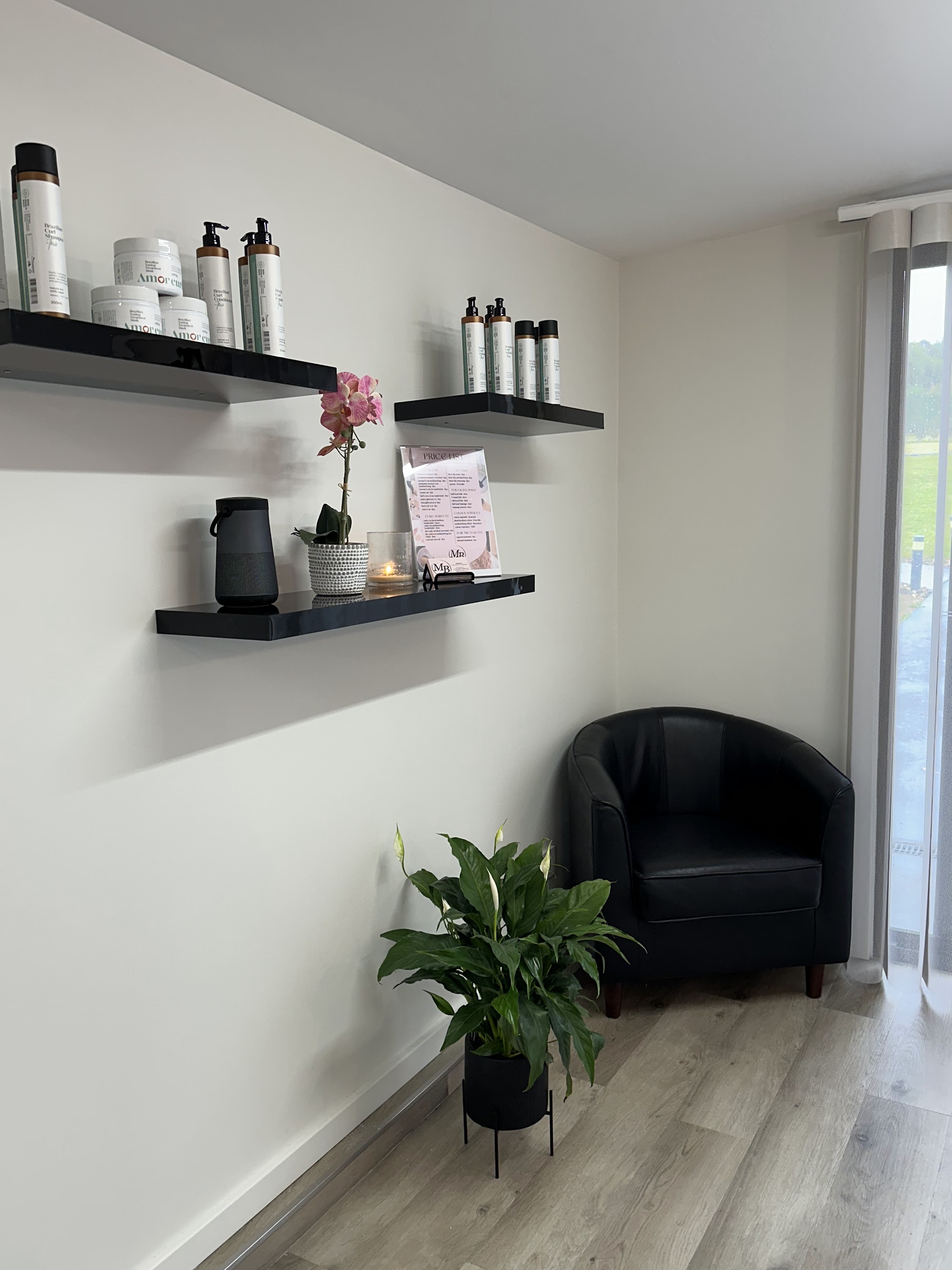 Curl care products on floating shelves beside a leather armchair